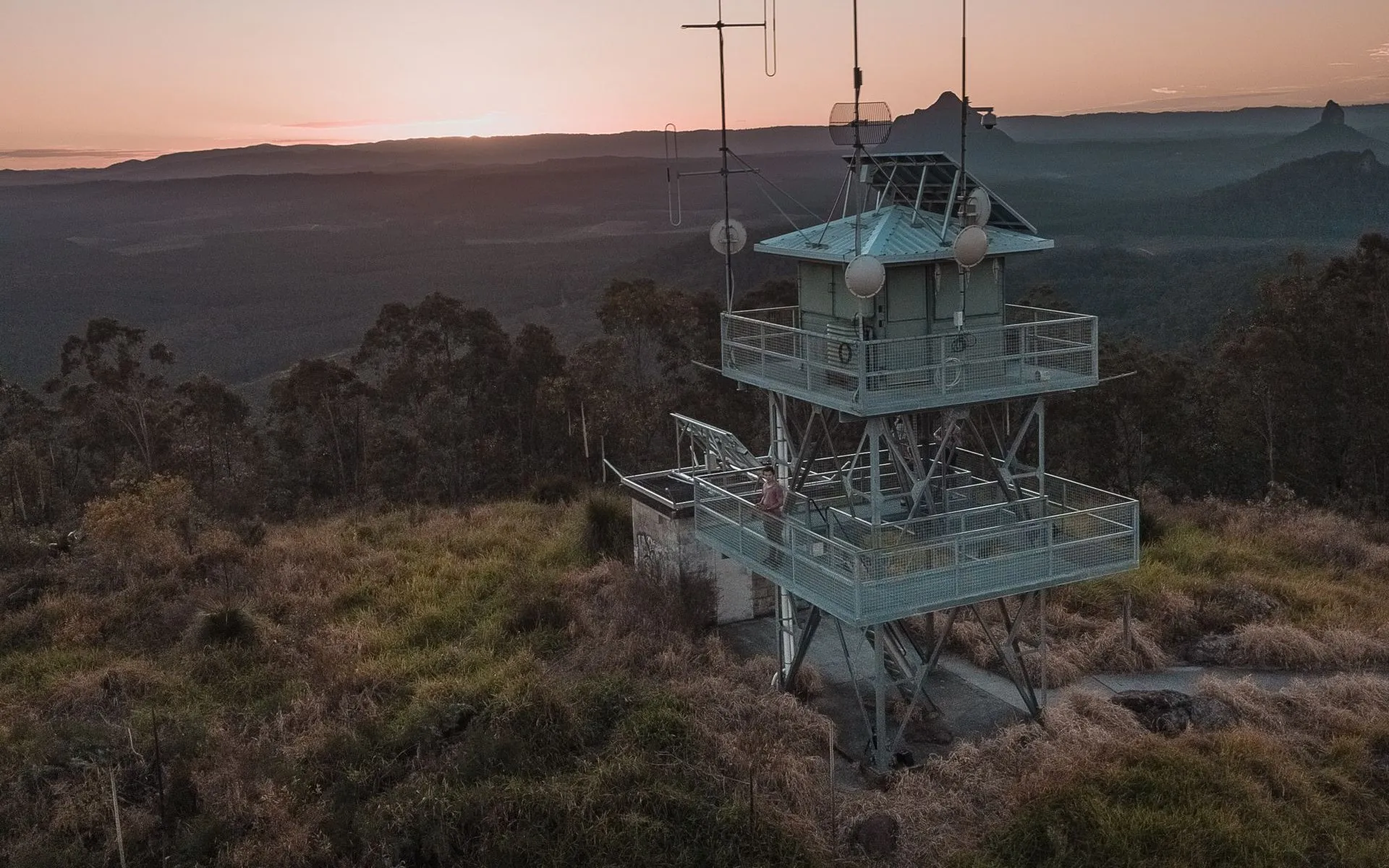 Communications tower on a remote hilltop at sunset
